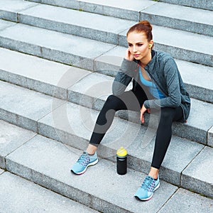 Young, fit and sporty brunette girl in sportswear. Woman doing sports outdoor.