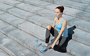 Young, fit and sporty brunette girl in sportswear. Woman doing sports outdoor.