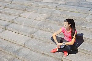 Young, fit and sporty girl resting after the training.