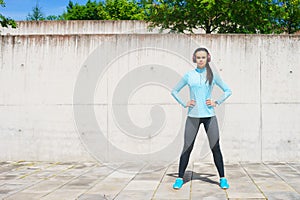 Young, fit and sporty girl in the street. Fitness, sport, urban jogging and healthy lifestyle concept.