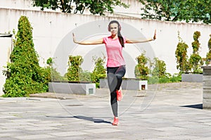 Young, fit and sporty woman doing yoga exercise outdoor. Fitness, sport, urban and healthy lifestyle concept.