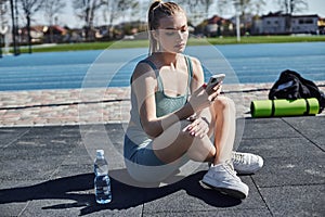 young fit woman in activewear using