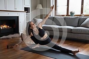 Young fit woman doing Side Lunge asana at home