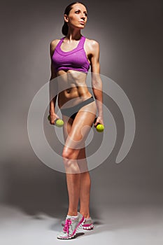 Young fit woman with dumbbells exercise