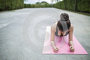 Young fit woman exercising in the park