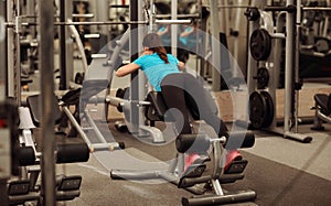 Young fit woman in a fitness center. Portrait of fitness girl in the gym, lifestyle concept.