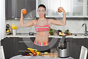 Young fit woman with fruits, in the kitchen