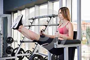 Young fit woman at the gym doing abs workout