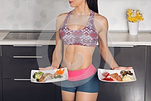 Young fit woman in the kitchen, preparing healthy meal