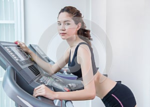 The young fit woman lifting dumbbells