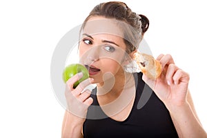 Young fit woman making decision what to eat