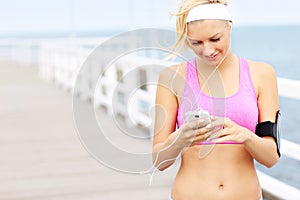 Young fit woman with phone