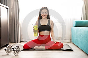 Young fit woman in sportwear doing everyday morning warm up exercises on the floor at home, sportive lifestyle