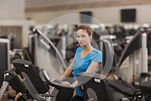 Young fit woman using a bicycle in a fitness center, cardio. Portrait of fitness girl in the gym, lifestyle concept.