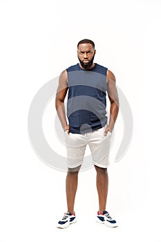 Young fitness african black man in sport wear cheering carefree isolated over white background.