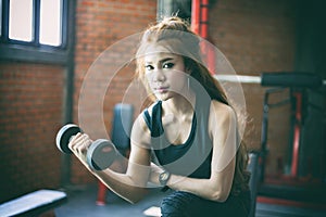 Young fitness asian woman exercise with machine Cable Crossover