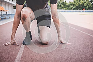 Young fitness athlete man preparing to running on road track, exercise workout wellness concept