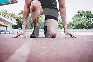 Young fitness athlete man preparing to running on road track, exercise workout wellness concept