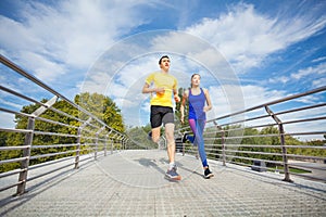 Young fitness couple running outdoors