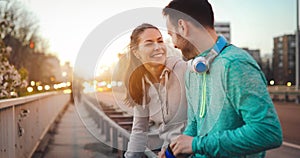 Young fitness couple running in urban area