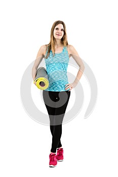 Young fitness girl with her exercise mat