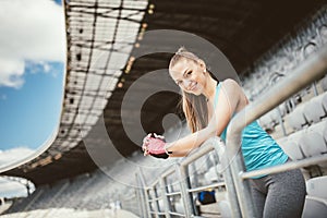 Young fitness instructor training on stadium stairs and working out. Fitness and healthy lifestyle concept