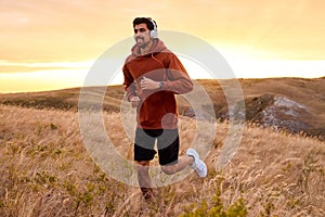 Young Fitness Male In Headphones Enjoy Running In Early Morning, Alone, In Nature