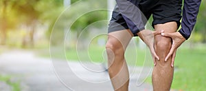 fitness man holding his sports injury, muscle painful during training photo