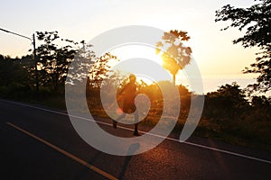 Young fitness man running on the road.