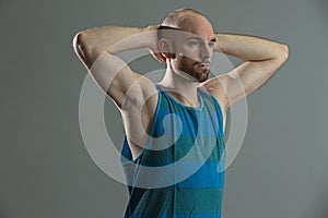 Young fitness man stretching his arms