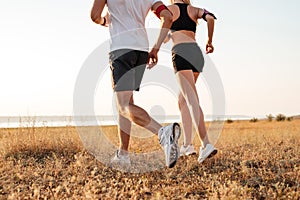 Young fitness man and woman doing jogging sport outdoors