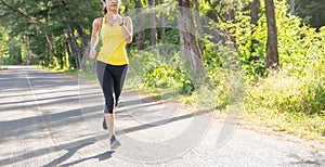 Young fitness sport woman running on the road in the morning, Young fitness sportswoman runner running on tropical park trail. Peo