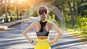 Young fitness sport woman running on the road in the morning, Young fitness sportswoman runner running on tropical park trail. Peo