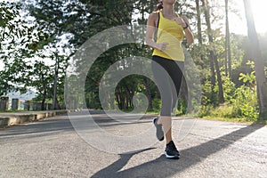 à¹Young fitness sports woman runner running on tropical park trail, Young fitness woman running at morning tropical forest trail