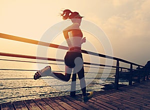 Young fitness sports woman trail runner running on seaside