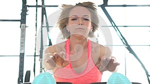 Young fitness woman doing abdominal exercise in the gym.