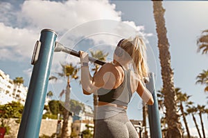 Young fitness woman doing exercises in park