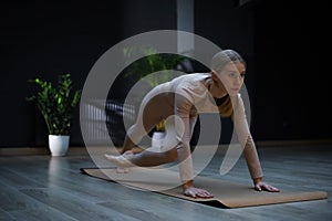 young fitness woman doing running plank exercise in gym, side view