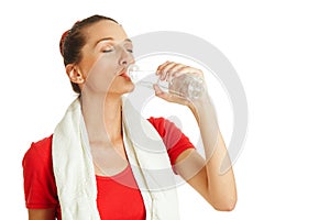 Young fitness woman drinking water from bottle