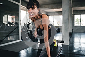 Young fitness woman execute exercise with exercise-machine in gym