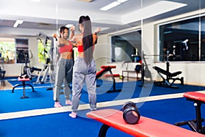 Young fitness woman execute exercise with exercise-machine in gym