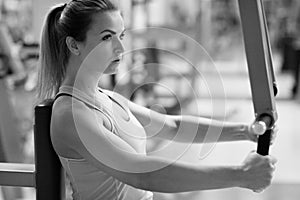 Young fitness woman execute exercise with exercise-machine in th