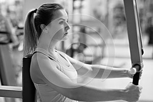 Young fitness woman execute exercise with exercise-machine in th