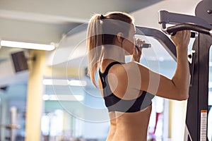 Young fitness woman execute exercise with exercise-machine in th