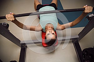 Young fitness woman execute exercise with exercise-machine in th