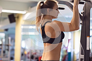 Young fitness woman execute exercise with exercise-machine in th