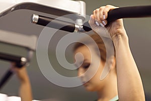 Young fitness woman execute exercise with exercise-machine in th