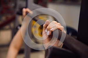 Young fitness woman execute exercise with exercise-machine in th