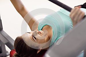 Young fitness woman execute exercise with exercise-machine in th