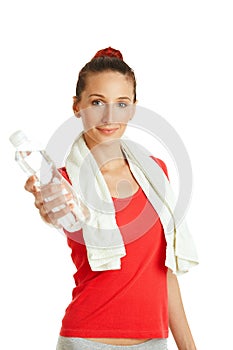 Young fitness woman giving bottle of water